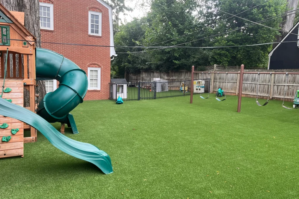 a lush, green artificial turf lawn in a residential backyard