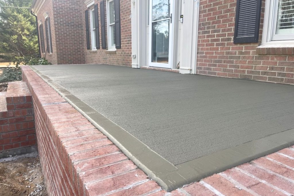 residential outdoor living space with brick retaining wall